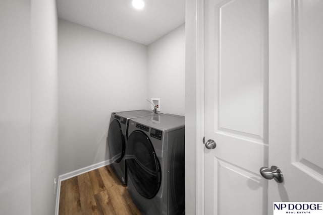 washroom featuring independent washer and dryer and hardwood / wood-style flooring