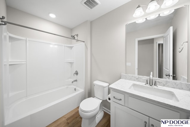 full bathroom featuring hardwood / wood-style flooring, vanity, toilet, and bathtub / shower combination