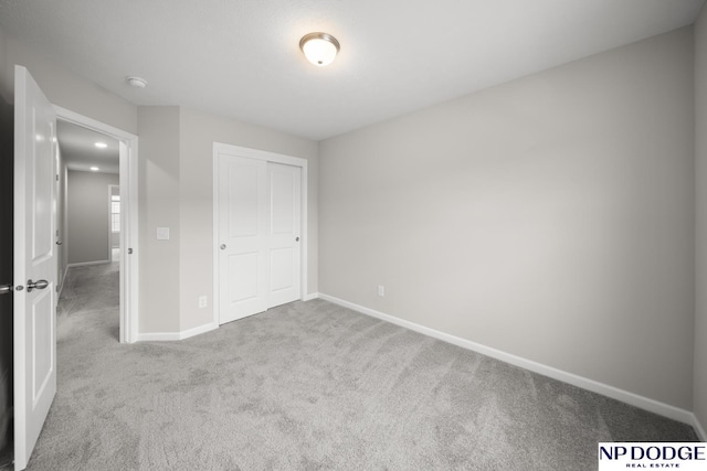 unfurnished bedroom with carpet flooring and a closet