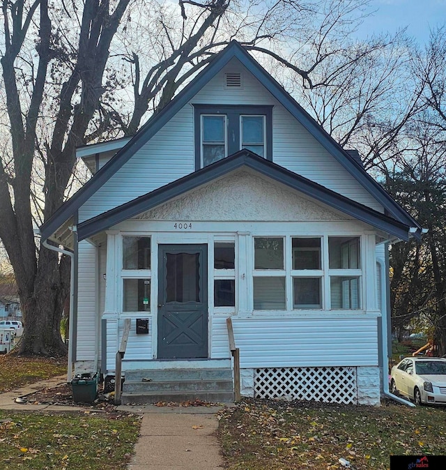 bungalow-style house featuring a sunroom