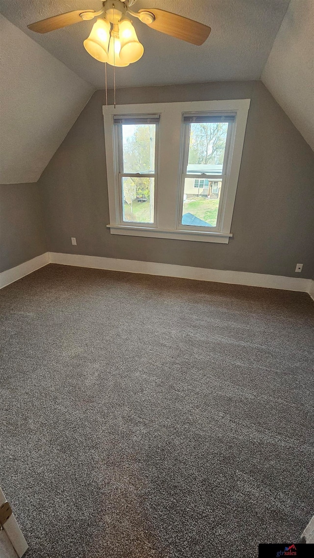 additional living space featuring carpet flooring, ceiling fan, a textured ceiling, and vaulted ceiling