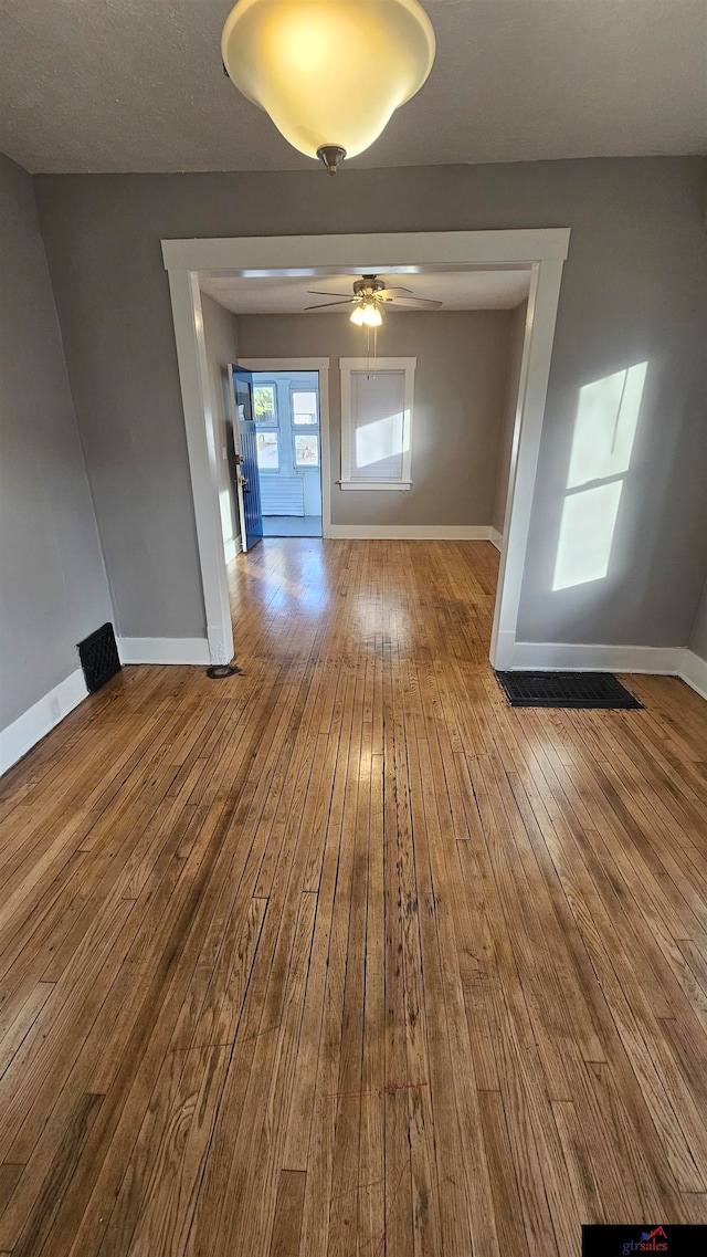 spare room featuring hardwood / wood-style floors and ceiling fan