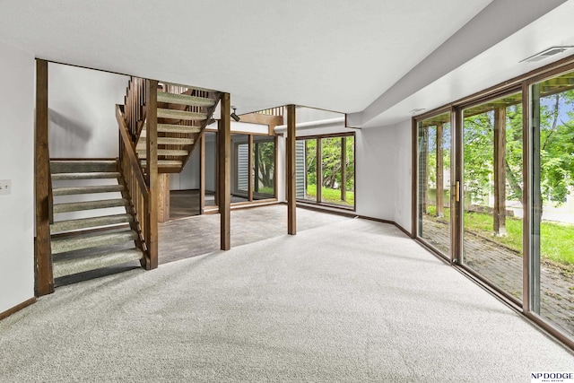 2729 N 129th Cir, Omaha, NE 68164 - unfurnished living room featuring carpet, baseboards, and stairway