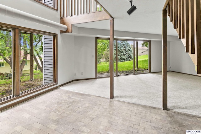 2729 N 129th Cir, Omaha, NE 68164 - unfurnished living room featuring baseboards and brick flooring