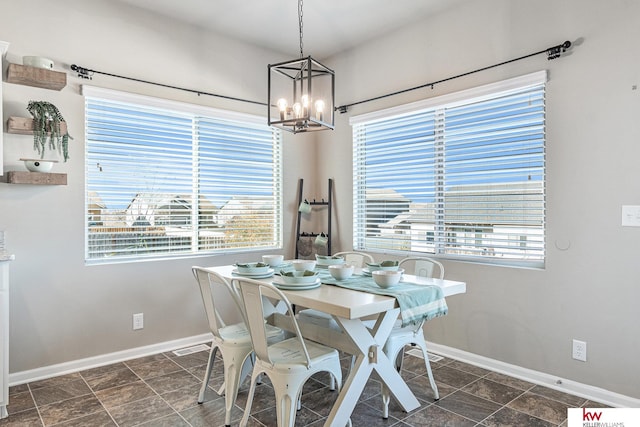 dining room featuring a chandelier and a healthy amount of sunlight