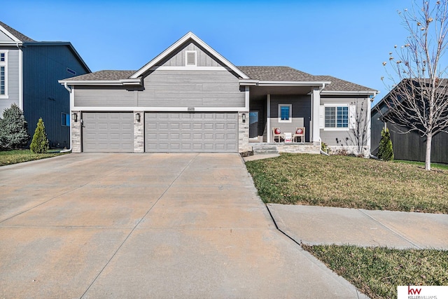 view of front of home featuring a front yard and a garage