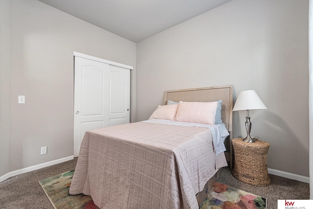 bedroom with dark colored carpet and a closet