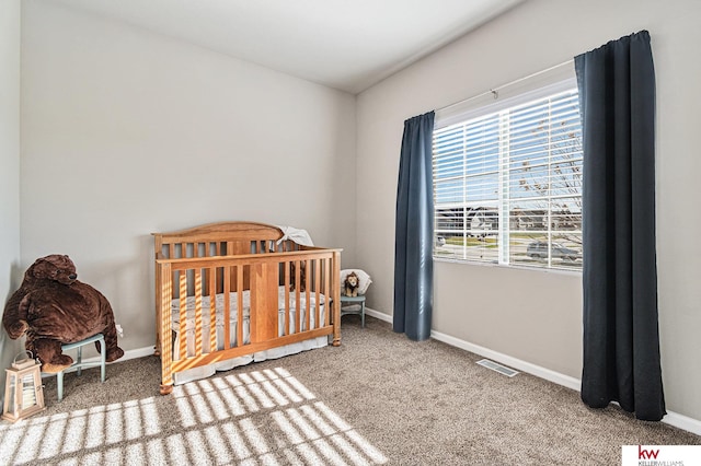 carpeted bedroom with a crib