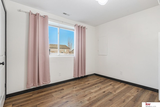 unfurnished room with hardwood / wood-style flooring