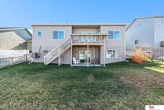 rear view of property featuring a patio area, a yard, and a deck