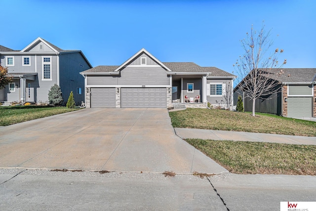 view of front of home with a front lawn and a garage