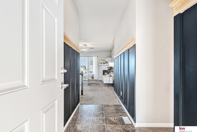 hallway with dark colored carpet