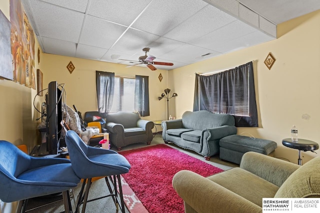 carpeted living room featuring a paneled ceiling and ceiling fan