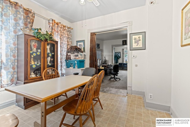 carpeted dining area featuring ceiling fan