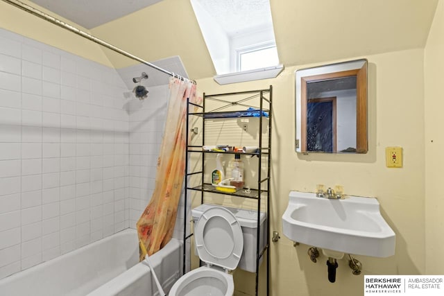 full bathroom featuring toilet, shower / bath combo with shower curtain, and sink