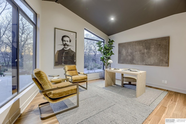 office area with hardwood / wood-style floors and lofted ceiling