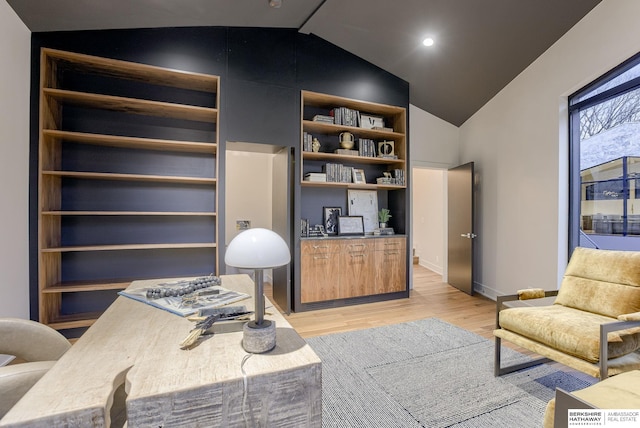 home office featuring light hardwood / wood-style floors and lofted ceiling