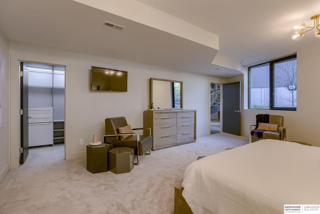 carpeted bedroom with multiple windows and an inviting chandelier