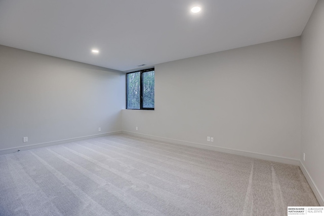 spare room featuring light colored carpet