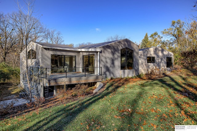 exterior space featuring a lawn and a wooden deck