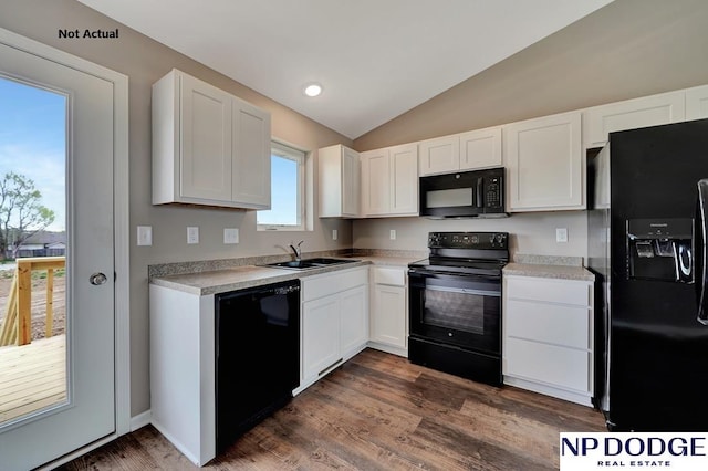 kitchen featuring black appliances, sink, vaulted ceiling, dark hardwood / wood-style flooring, and white cabinetry