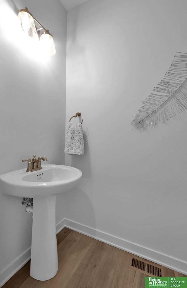 11018 N 161st St, Bennington, NE 68007 - bathroom featuring wood finished floors, baseboards, and a sink