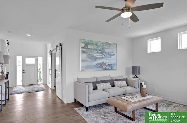 11018 N 161st St, Bennington, NE 68007 - living area with a barn door, wood finished floors, a ceiling fan, and baseboards