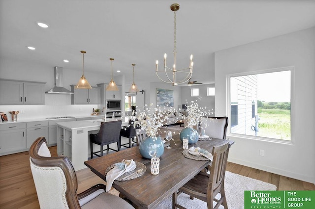 dining space featuring light hardwood / wood-style flooring and a notable chandelier