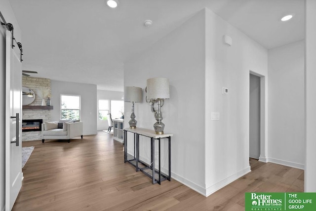 11018 N 161st St, Bennington, NE 68007 - hallway with wood finished floors, baseboards, a barn door, and recessed lighting