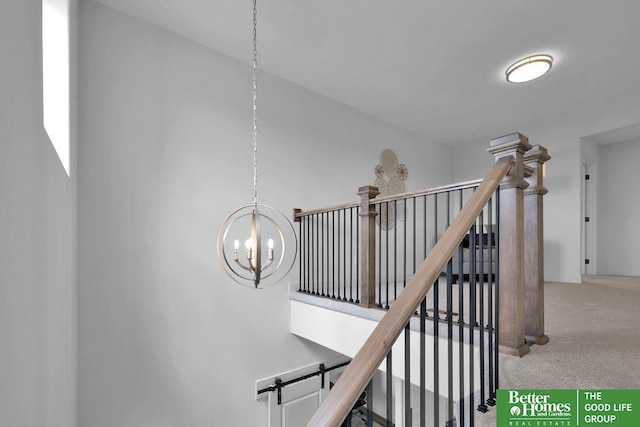 stairs with a notable chandelier and carpet floors