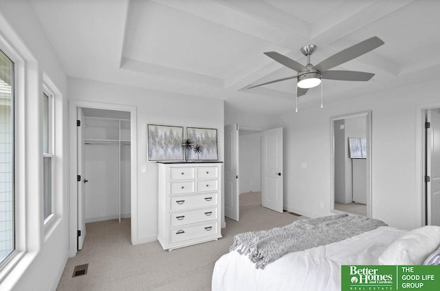 bedroom with ceiling fan, a closet, light carpet, and multiple windows