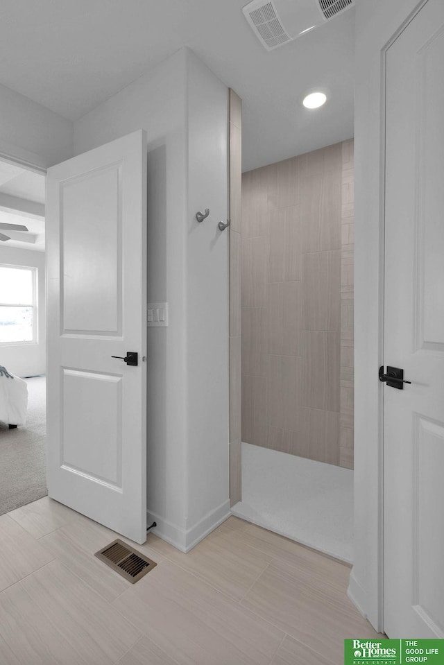 bathroom with tiled shower