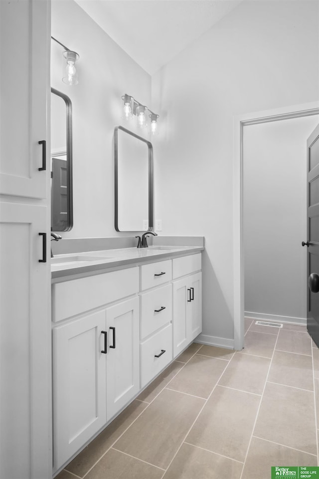 bathroom featuring tile patterned flooring and vanity