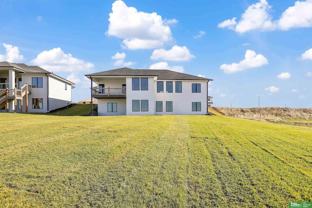 back of property featuring a yard and a balcony