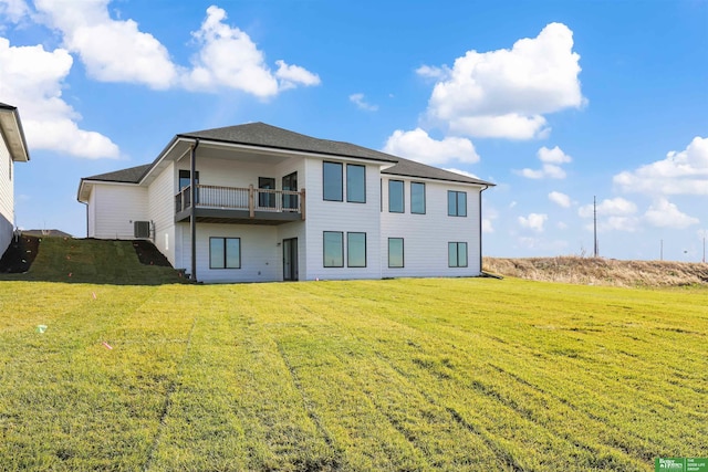 rear view of property with central AC and a yard