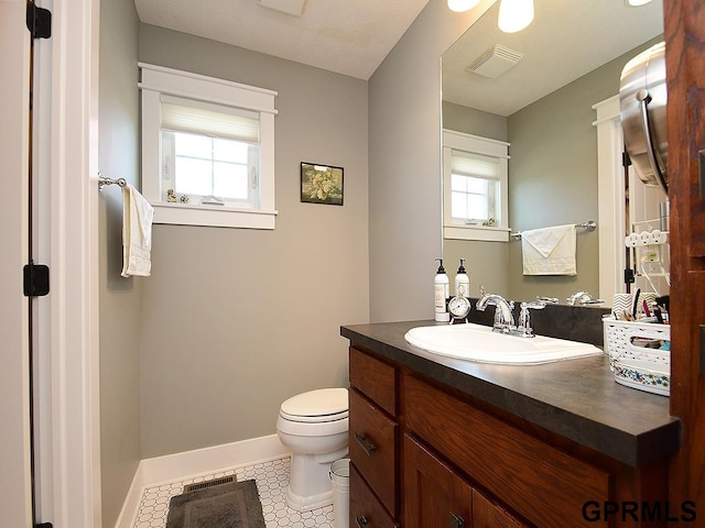 bathroom with tile patterned floors, vanity, and toilet