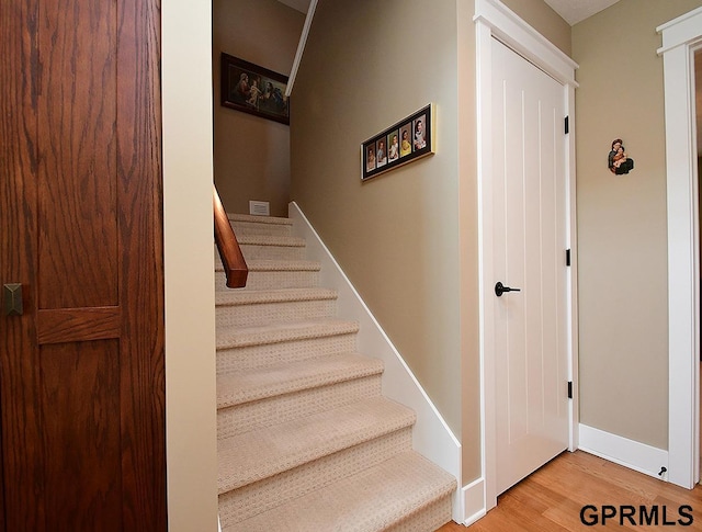 stairs with hardwood / wood-style flooring