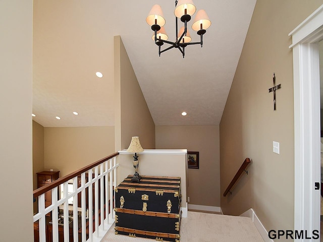 stairway with carpet flooring and an inviting chandelier