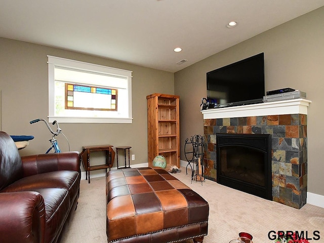 living room featuring a fireplace and carpet