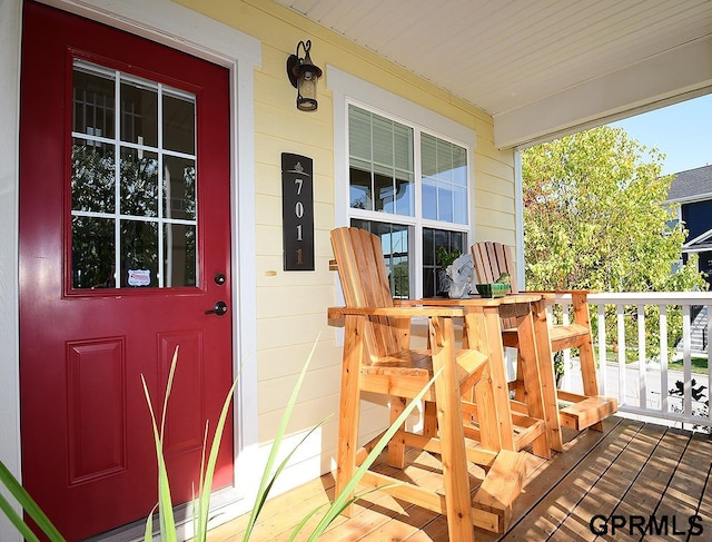 view of exterior entry with covered porch