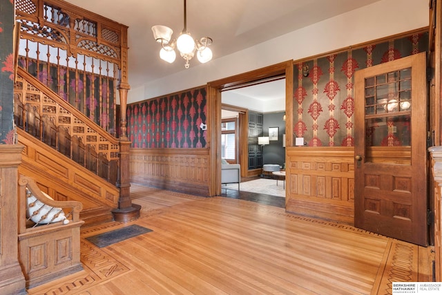 entryway featuring hardwood / wood-style flooring and an inviting chandelier