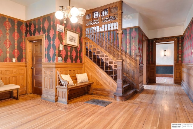 stairway featuring a chandelier and hardwood / wood-style floors