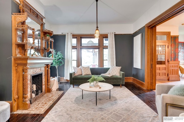 living room with dark hardwood / wood-style flooring and a premium fireplace