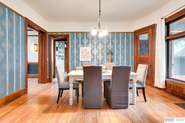 dining space featuring a chandelier and light hardwood / wood-style flooring