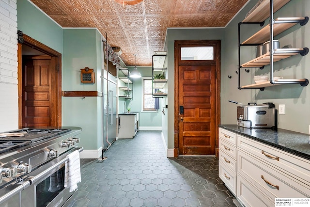 kitchen with white cabinetry and high end stainless steel range oven