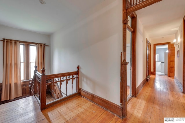 corridor with light hardwood / wood-style floors