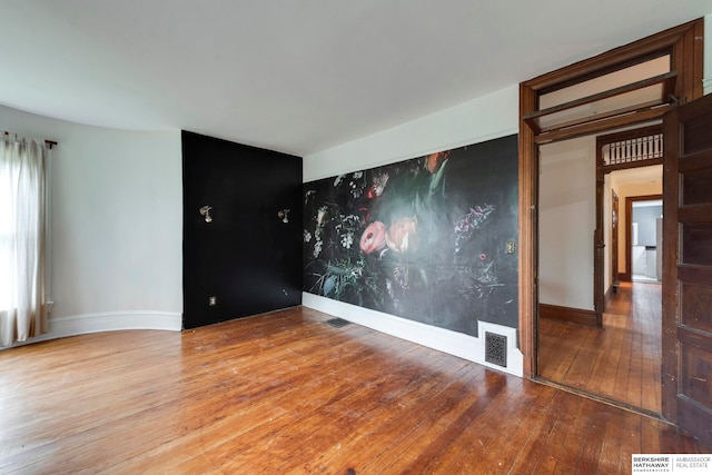 spare room with wood-type flooring