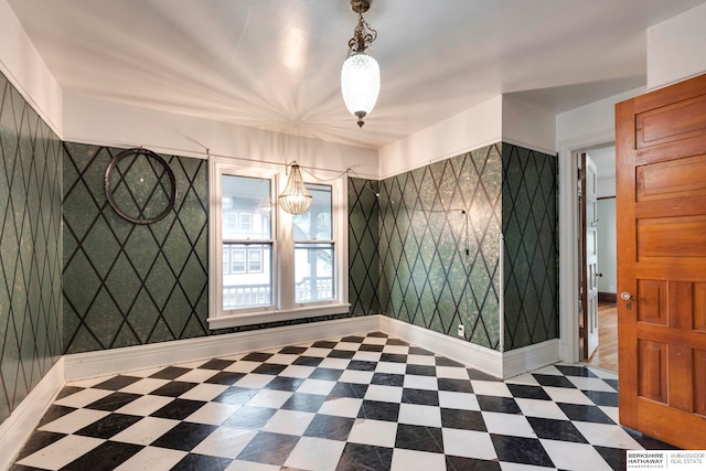 unfurnished room featuring a notable chandelier