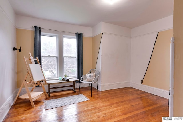 sitting room with hardwood / wood-style flooring