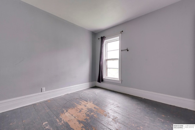 empty room with dark hardwood / wood-style flooring